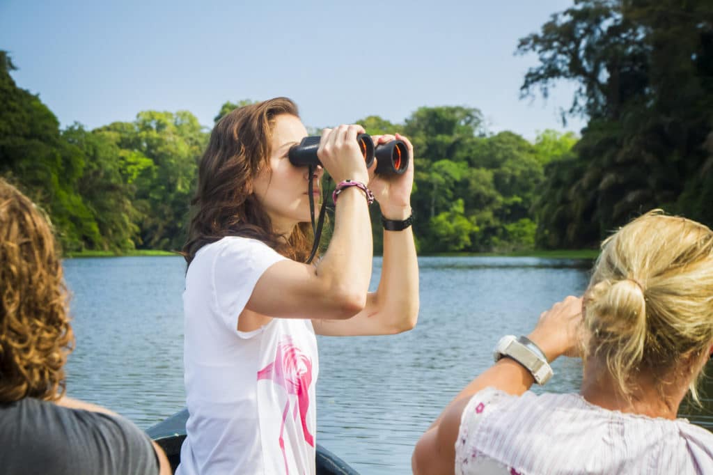 Paradise In Jaco Girl Looking Through Binoculars From A Canoe In Uh